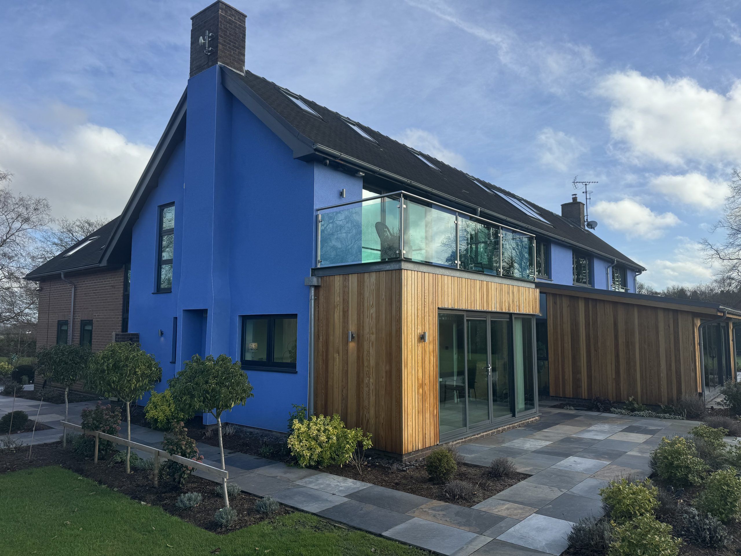 Render repair specialist inspecting cracked external wall render by SM Rendering